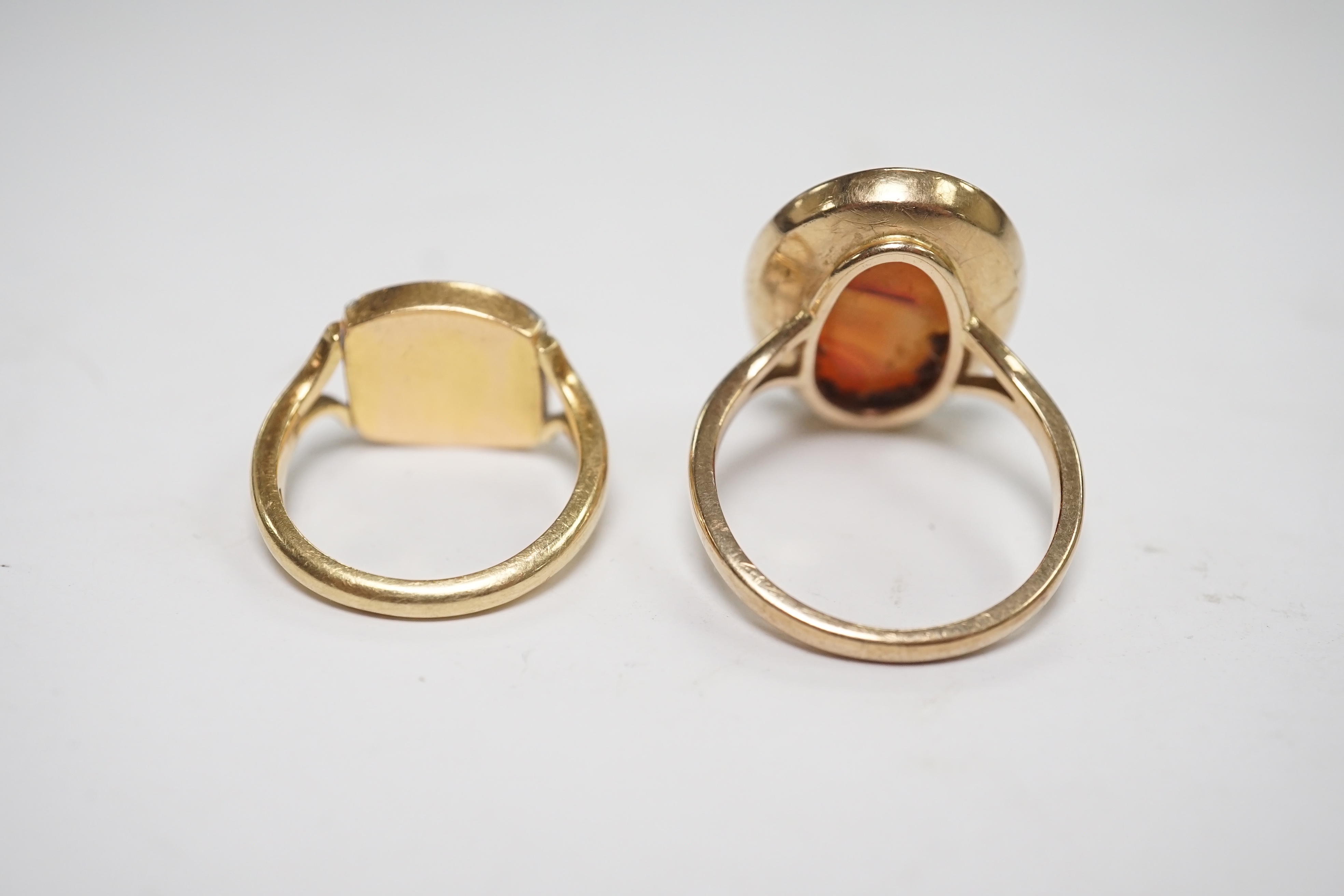 A yellow metal and intaglio agate set oval ring, size P, together with a modern 18ct gold signet ring, engraved with a bird, gross weight 12.3 grams. Condition - poor to fair